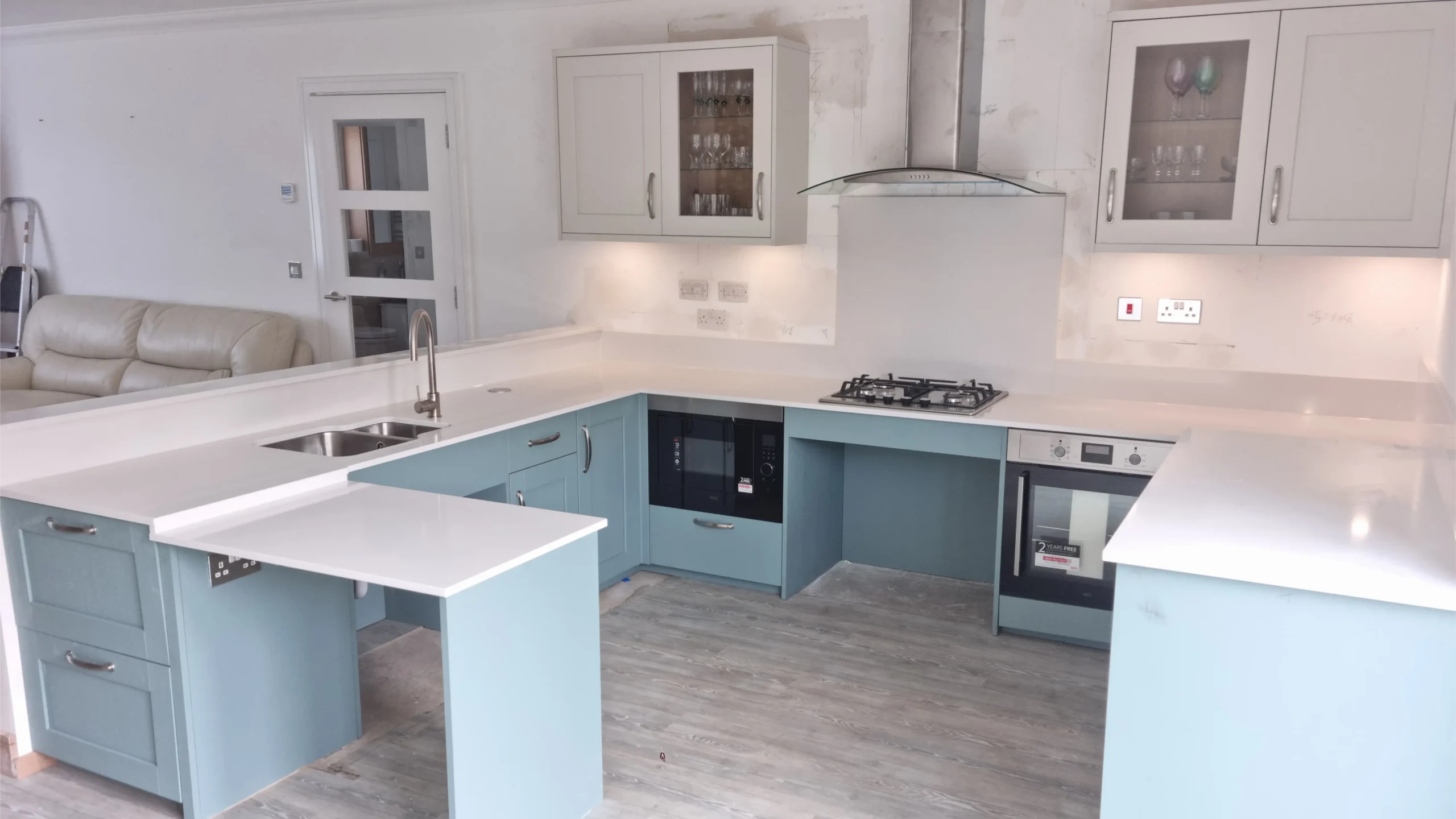 Pale blue shaker-style kitchen with a breakfast bar